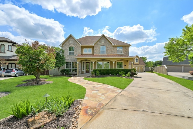 314 Del Monte Dr, Friendswood, TX 77546 - traditional-style home with a standing seam roof, driveway, a porch, brick siding, and a front yard