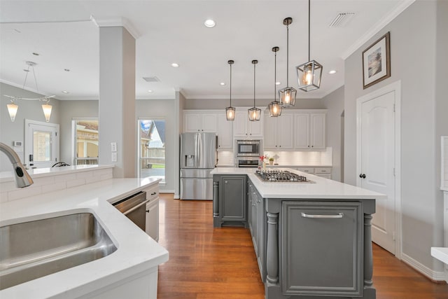 314 Del Monte Dr, Friendswood, TX 77546 - kitchen featuring crown molding, a sink, white cabinets, appliances with stainless steel finishes, and gray cabinetry
