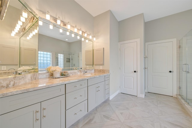314 Del Monte Dr, Friendswood, TX 77546 - bathroom with a shower stall, baseboards, a sink, and double vanity