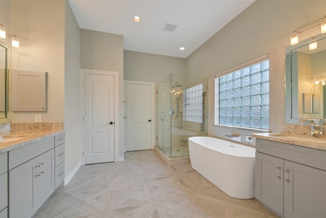 314 Del Monte Dr, Friendswood, TX 77546 - bathroom featuring a sink, a stall shower, a freestanding tub, two vanities, and visible vents