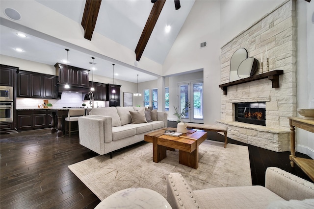 182 River Wilde Dr, Montgomery, TX 77316 - living room featuring a stone fireplace, high vaulted ceiling, dark wood-style floors, beamed ceiling, and recessed lighting