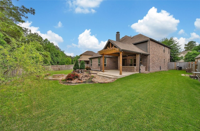 182 River Wilde Dr, Montgomery, TX 77316 - back of property featuring a patio, a chimney, brick siding, a fire pit, and roof with shingles