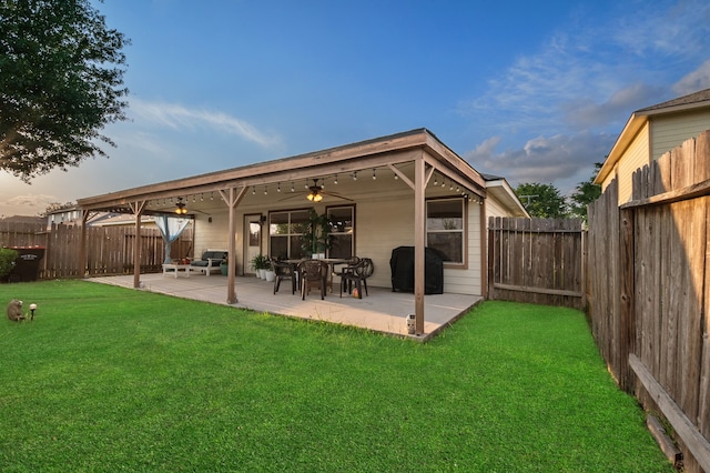 19515 Buckland Park Dr, Katy, TX 77449 - rear view of house featuring a fenced backyard, a ceiling fan, a yard, and a patio