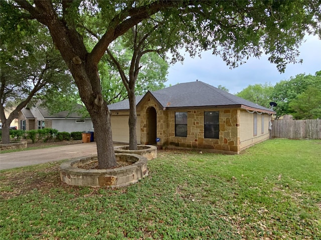 view of front of property featuring a garage, fence, a front lawn, concrete driveway, and stone siding