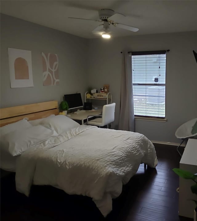 bedroom with baseboards, a ceiling fan, and dark wood finished floors