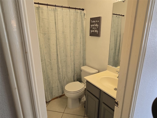 bathroom with vanity, tile patterned flooring, and toilet