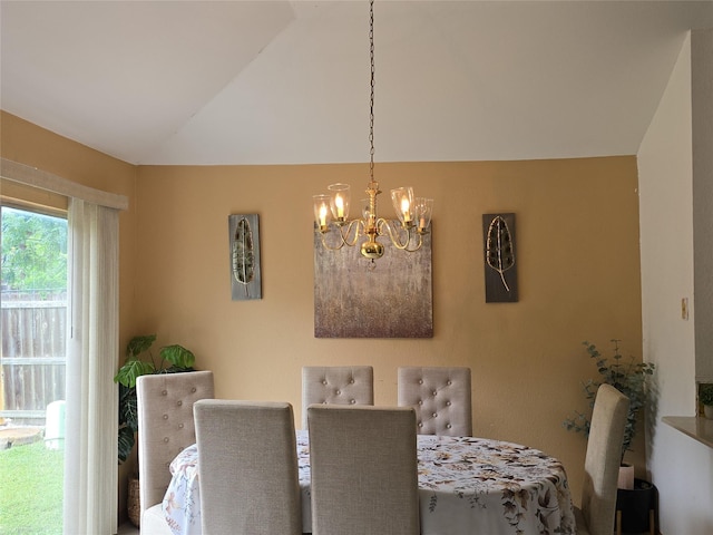 dining room featuring an inviting chandelier and lofted ceiling