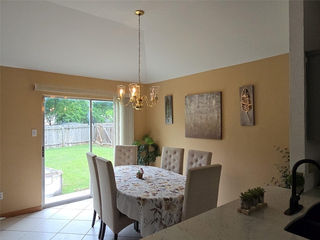 dining space featuring baseboards, light tile patterned flooring, a chandelier, and vaulted ceiling