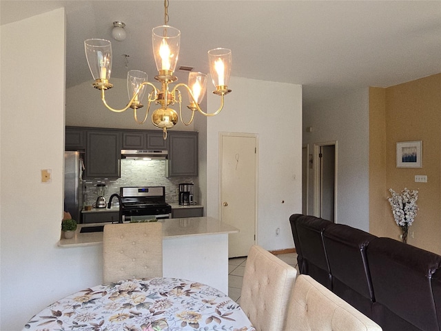 dining area featuring light tile patterned floors and a notable chandelier