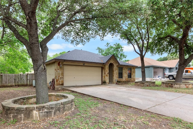 2403 Lendall Ln, Austin, TX 78744 - single story home featuring a garage, fence, concrete driveway, and stone siding