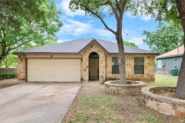 2403 Lendall Ln, Austin, TX 78744 - view of front of home featuring a garage, a shingled roof, driveway, and stone siding