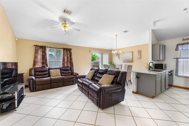 2403 Lendall Ln, Austin, TX 78744 - living room with visible vents, a healthy amount of sunlight, lofted ceiling, and ceiling fan with notable chandelier