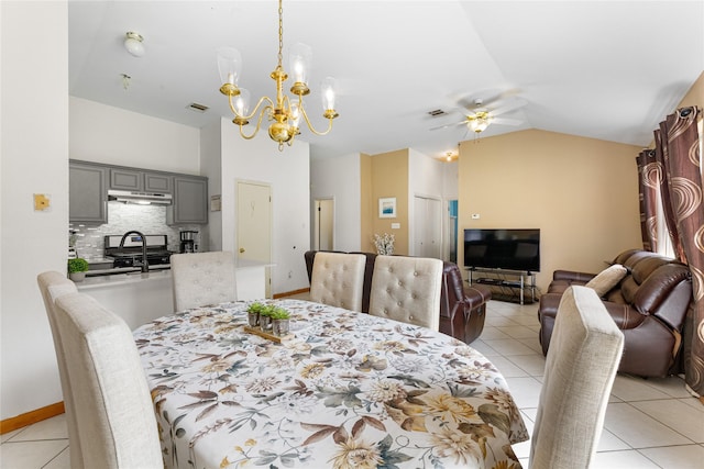 2403 Lendall Ln, Austin, TX 78744 - dining room featuring light tile patterned floors, vaulted ceiling, ceiling fan with notable chandelier, and visible vents