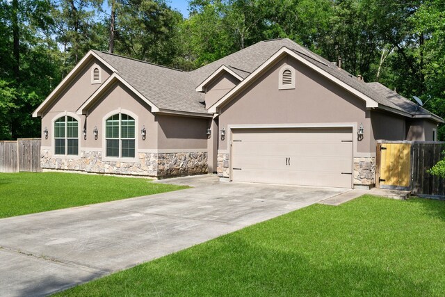17111 Paluxy Ct, Splendora, TX 77372 - ranch-style home featuring stone siding, stucco siding, roof with shingles, an attached garage, and driveway