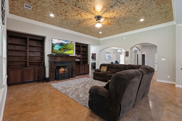 17111 Paluxy Ct, Splendora, TX 77372 - living room with arched walkways, ceiling fan, built in shelves, a premium fireplace, and recessed lighting