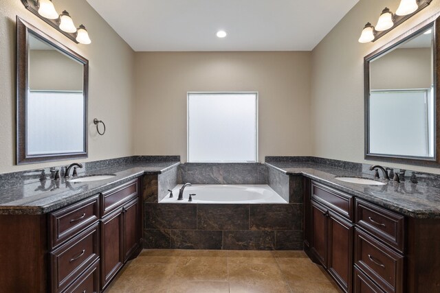 17111 Paluxy Ct, Splendora, TX 77372 - bathroom featuring two vanities, a garden tub, and recessed lighting
