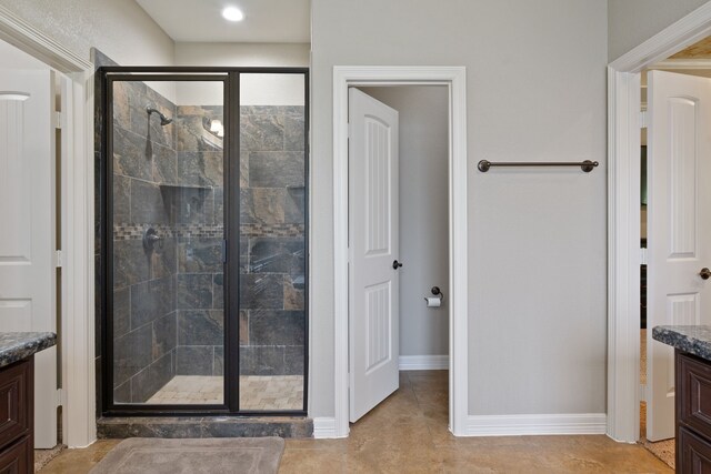17111 Paluxy Ct, Splendora, TX 77372 - bathroom with vanity, a shower stall, baseboards, and tile patterned flooring