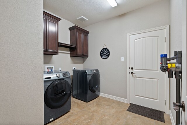 17111 Paluxy Ct, Splendora, TX 77372 - laundry room featuring washer and clothes dryer, cabinet space, baseboards, and light tile patterned floors