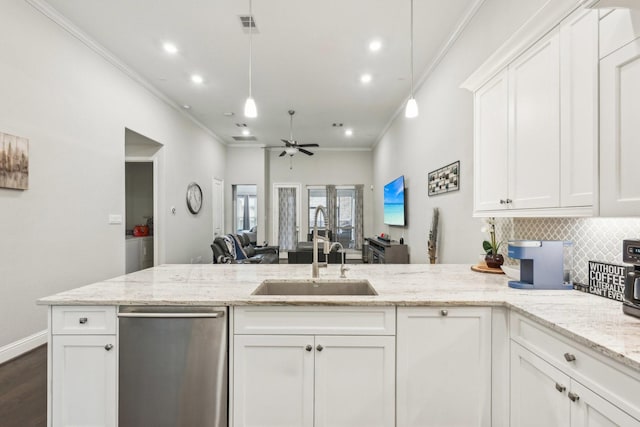 kitchen with crown molding, a peninsula, dishwasher, a sink, and backsplash