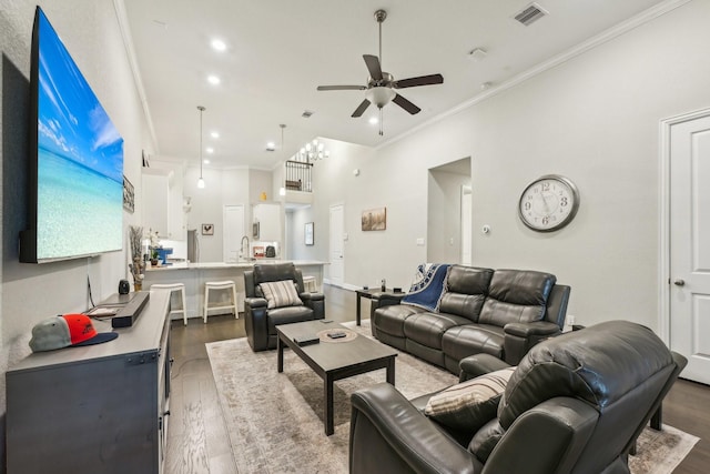 living area featuring ceiling fan, visible vents, crown molding, wood finished floors, and recessed lighting