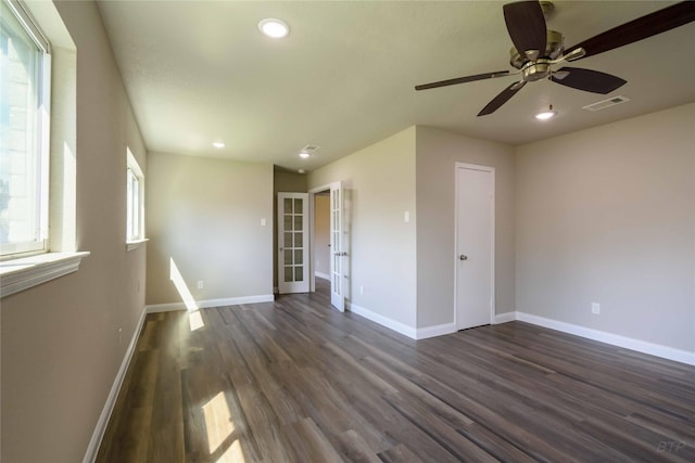 unfurnished room with a ceiling fan, baseboards, dark wood-style flooring, visible vents, and recessed lighting