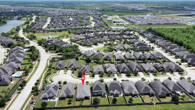 birds eye view of property featuring a residential view and a water view