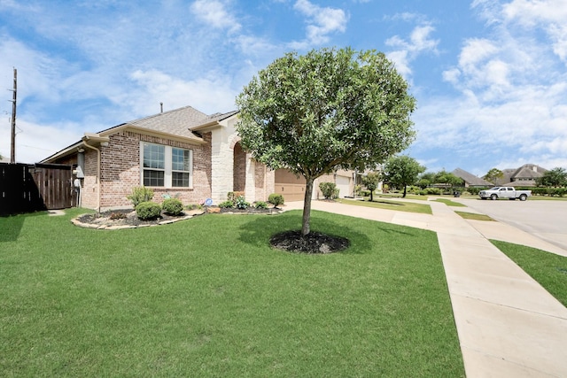 view of front of home featuring concrete driveway, a front lawn, brick siding, and a garage