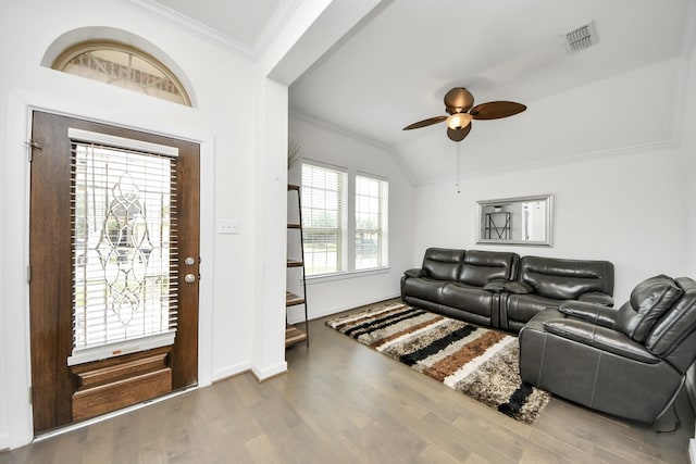foyer entrance with crown molding, wood finished floors, ceiling fan, baseboards, and visible vents