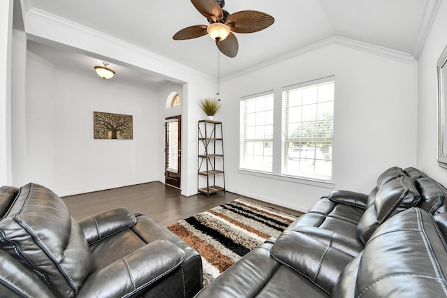 living area featuring lofted ceiling, a ceiling fan, dark wood-type flooring, and ornamental molding