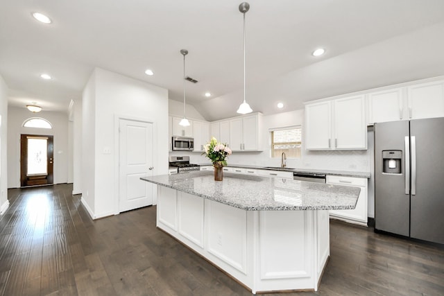 kitchen featuring a sink, stainless steel appliances, white cabinetry, dark wood-type flooring, and a kitchen island