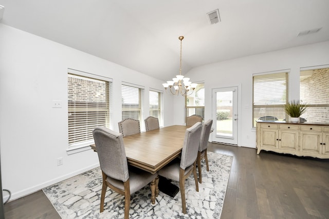 dining space with dark wood finished floors, vaulted ceiling, baseboards, visible vents, and a chandelier