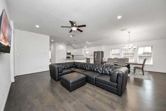 living room with ceiling fan with notable chandelier, recessed lighting, and dark wood-style flooring