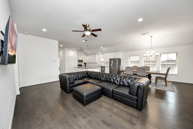 living area with recessed lighting, dark wood-style flooring, visible vents, and ceiling fan with notable chandelier