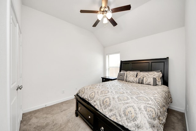 carpeted bedroom featuring ceiling fan, baseboards, and vaulted ceiling
