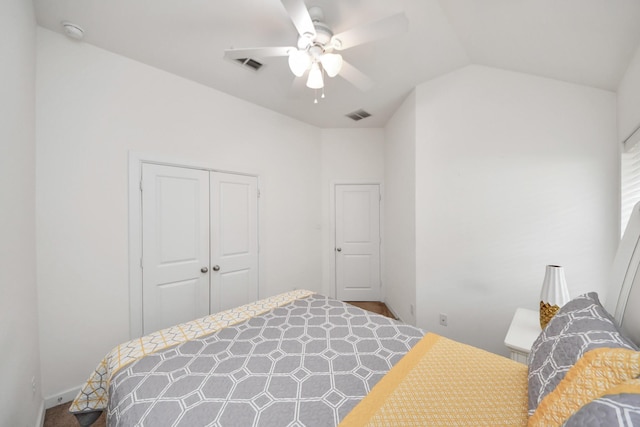 bedroom with a closet, lofted ceiling, visible vents, and ceiling fan