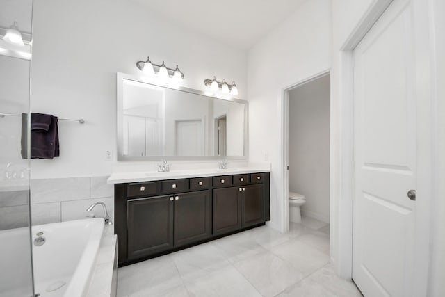 full bath featuring tiled tub, a sink, double vanity, and toilet