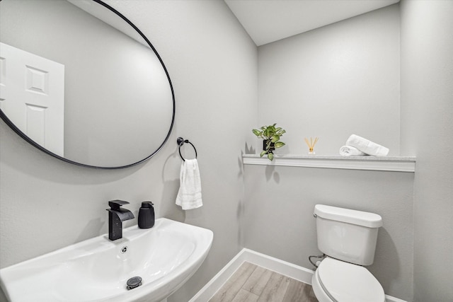 765 Enterprise St Unit C, Houston, TX 77088 - half bath with wood finished floors, toilet, baseboards, and a sink