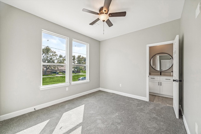 765 Enterprise St Unit C, Houston, TX 77088 - unfurnished bedroom with connected bathroom, ceiling fan, light carpet, and baseboards