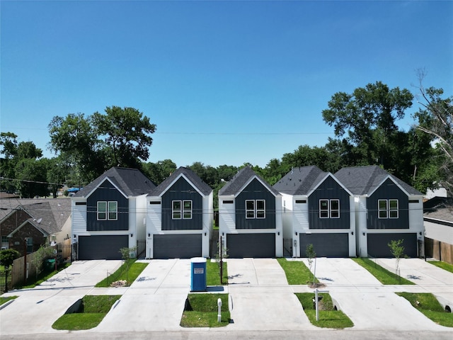 765 Enterprise St Unit C, Houston, TX 77088 - view of front of property with concrete driveway, an attached garage, and board and batten siding