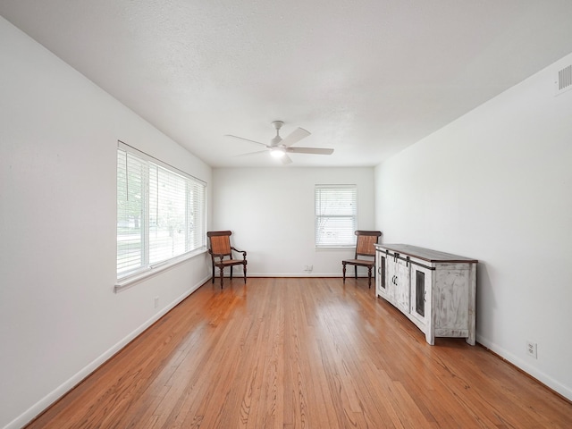 9710 Bassoon Dr, Houston, TX 77025 - living area with baseboards, light wood-style floors, and ceiling fan