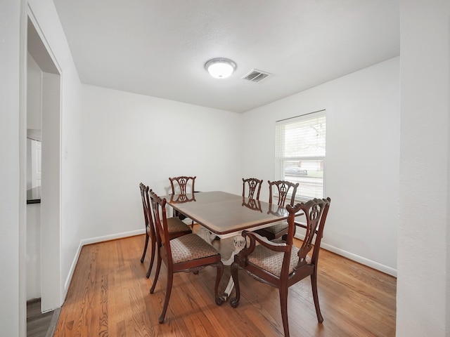 9710 Bassoon Dr, Houston, TX 77025 - dining area featuring light wood finished floors, baseboards, and visible vents