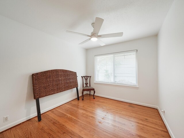 9710 Bassoon Dr, Houston, TX 77025 - sitting room with baseboards, a ceiling fan, and wood finished floors