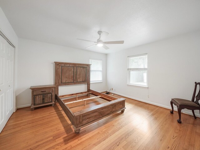9710 Bassoon Dr, Houston, TX 77025 - bedroom with light wood-style flooring, baseboards, a closet, and a ceiling fan