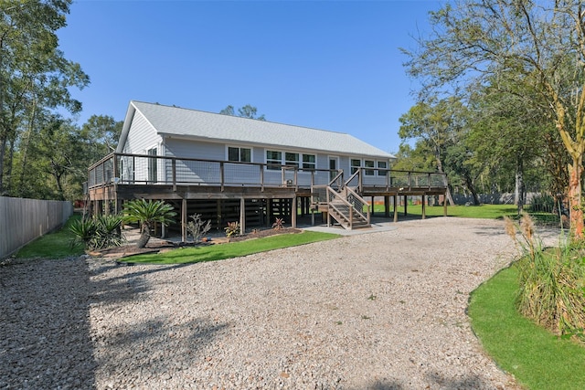 6310 Wickwillow Ln, Alvin, TX 77511 - back of house with driveway, stairs, fence, and a deck