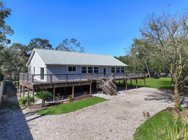 6310 Wickwillow Ln, Alvin, TX 77511 - back of house with stairs, a yard, a wooden deck, driveway, and roof with shingles