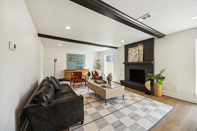 living area with a fireplace, recessed lighting, and light wood-style flooring