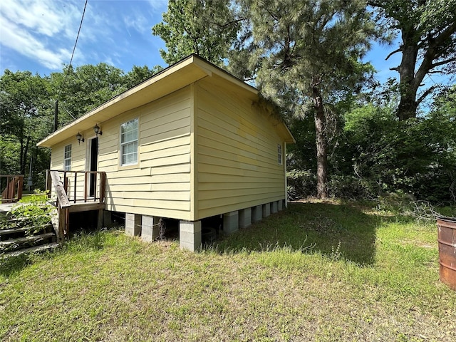 view of property exterior featuring a lawn