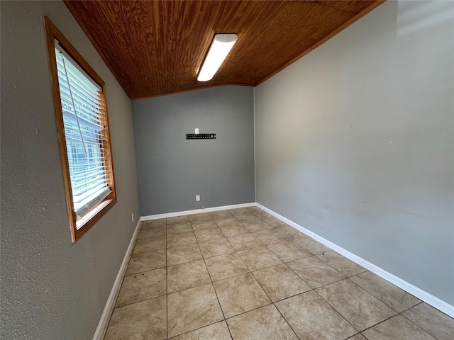 empty room featuring wooden ceiling, vaulted ceiling, and light tile patterned floors