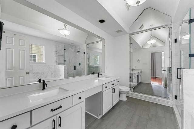full bathroom with visible vents, a sink, double vanity, and a stall shower