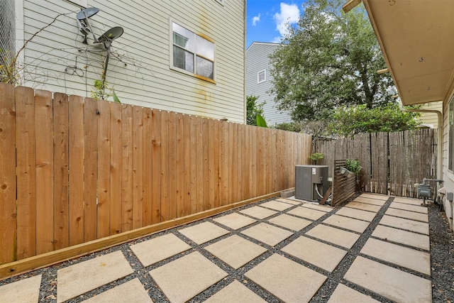 view of patio / terrace with cooling unit and fence